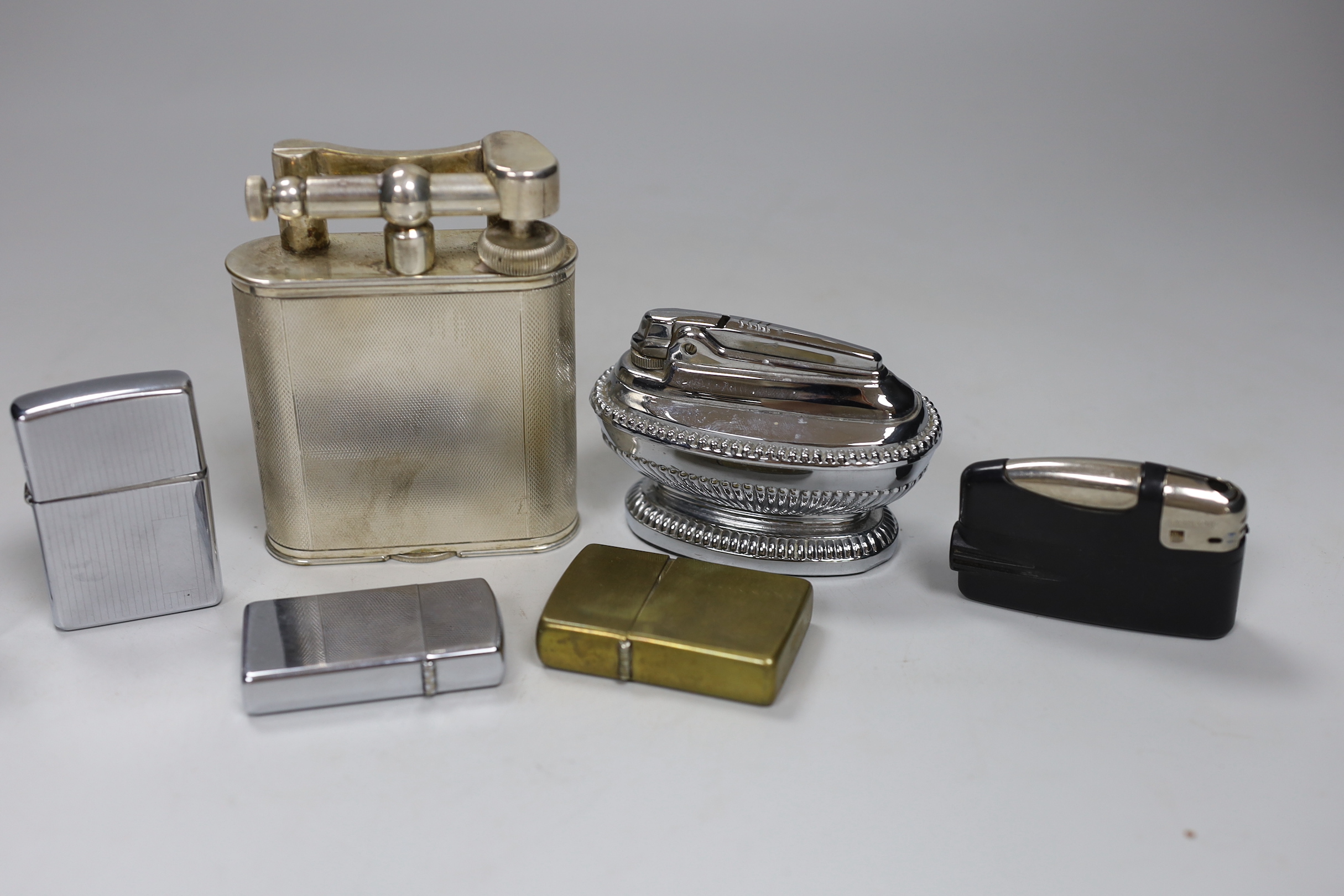 A Dunhill plated table lighter and six various other lighters, Dunhill table lighter 10cm high